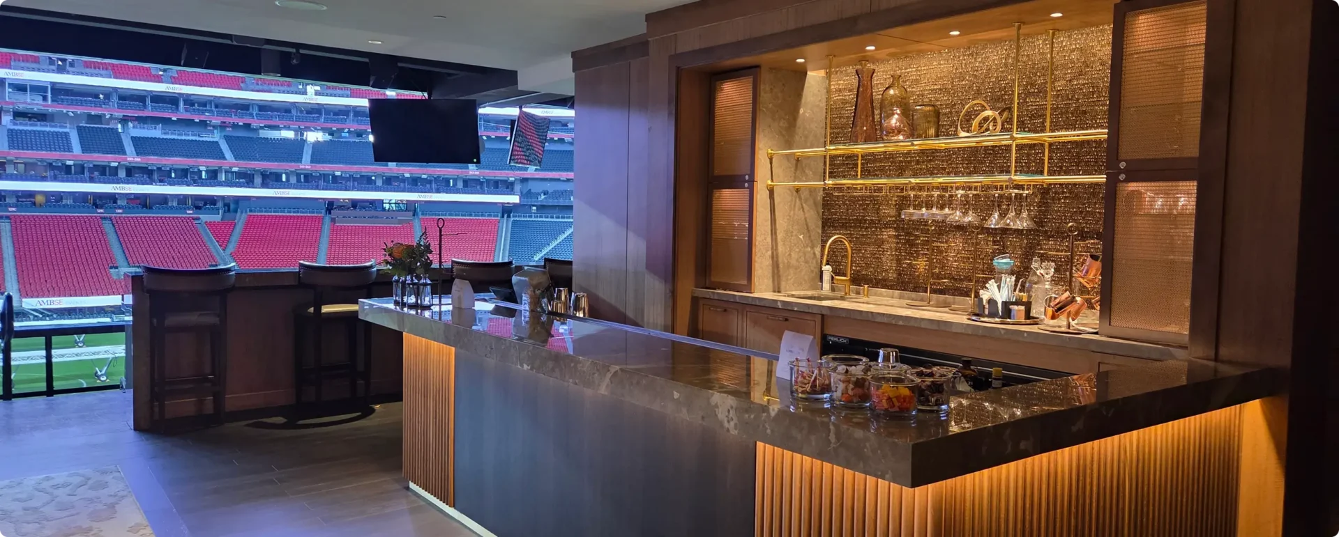 Luxury stadium suite with bar and view.